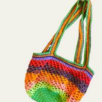 Side view of the Lil Sis Funky handmade crochet bag with green handles, multicolor mesh body in neon tones, designed in Paris by Anabaum