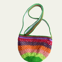 Full product view of the Lil Sis Funky crochet shoulder bag on a cream background, rounded shape with green strap and vibrant neon stripe pattern, designed in Paris by Anabaum