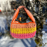 Close-up of the Anabaum Boxy Vibe bag's intricate waffle-stitch crochet pattern in premium pink to yellow to orange cord.