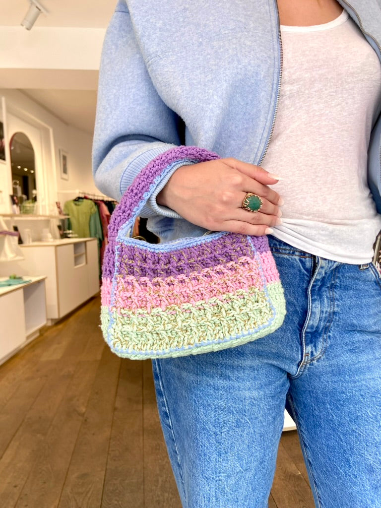 Designer Anabaum Boxy bag in pink and green technical crochet paired with a jean, white tshirt, sweatshirt and beautiful ring