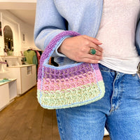 Designer Anabaum Boxy bag in pink and green technical crochet paired with a jean, white tshirt, sweatshirt and beautiful ring