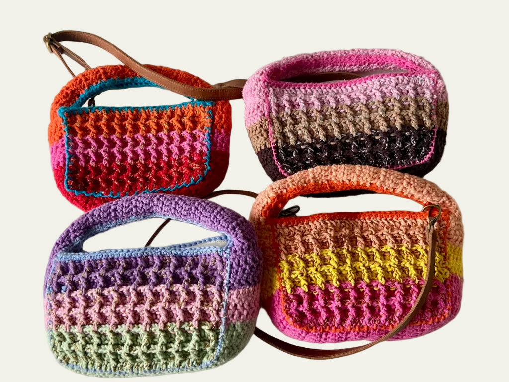 Four Anabaum Boxy bags in multi-tonal yarn showcasing premium textile textures and seasonal trend colors.