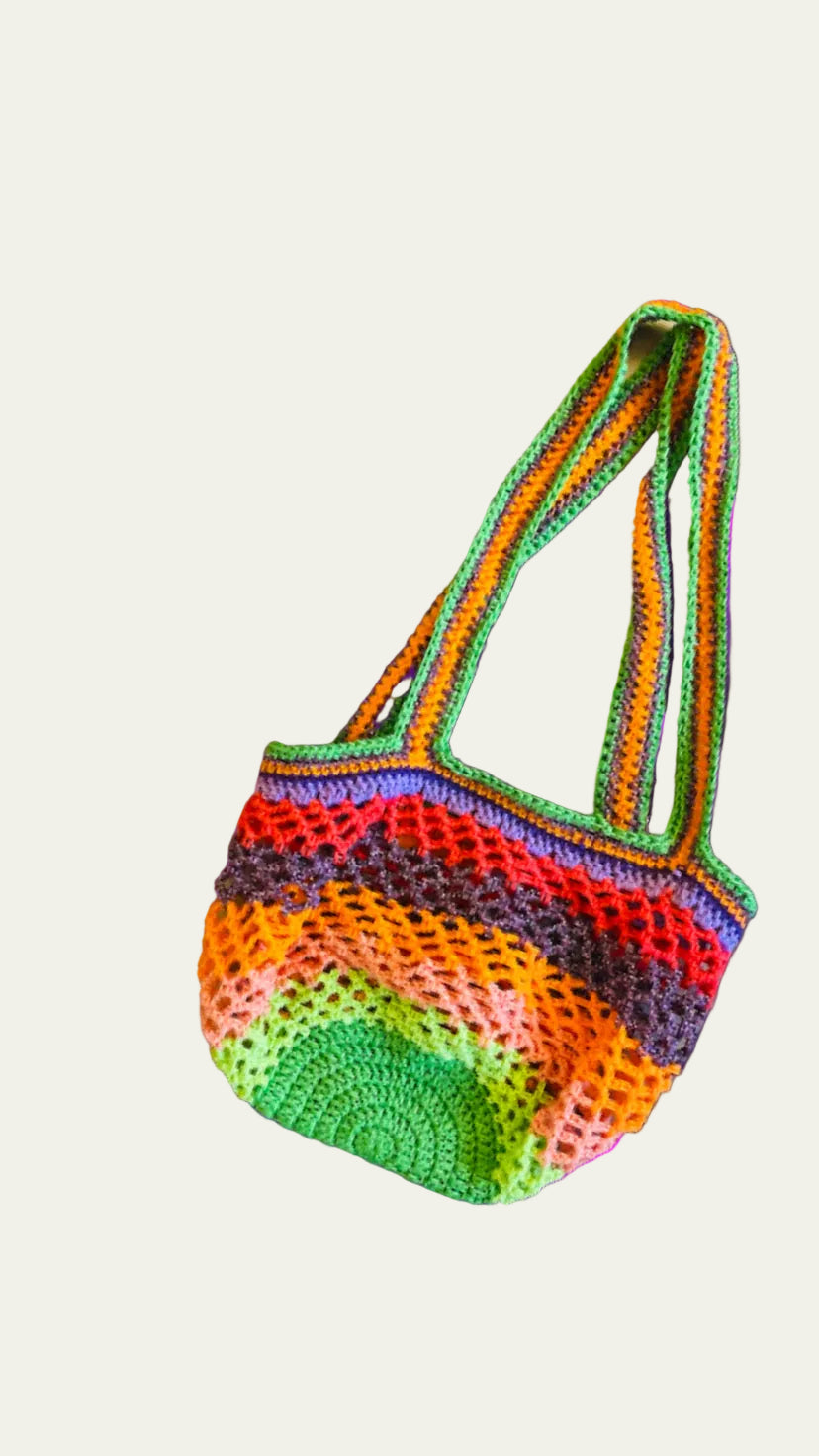 Side view of the Lil Sis Funky handmade crochet bag with green handles, multicolor mesh body in neon tones, designed in Paris by Anabaum