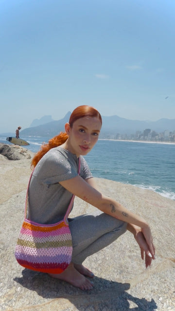 femme portant le sac anabaum courier sunset au bord de la plage